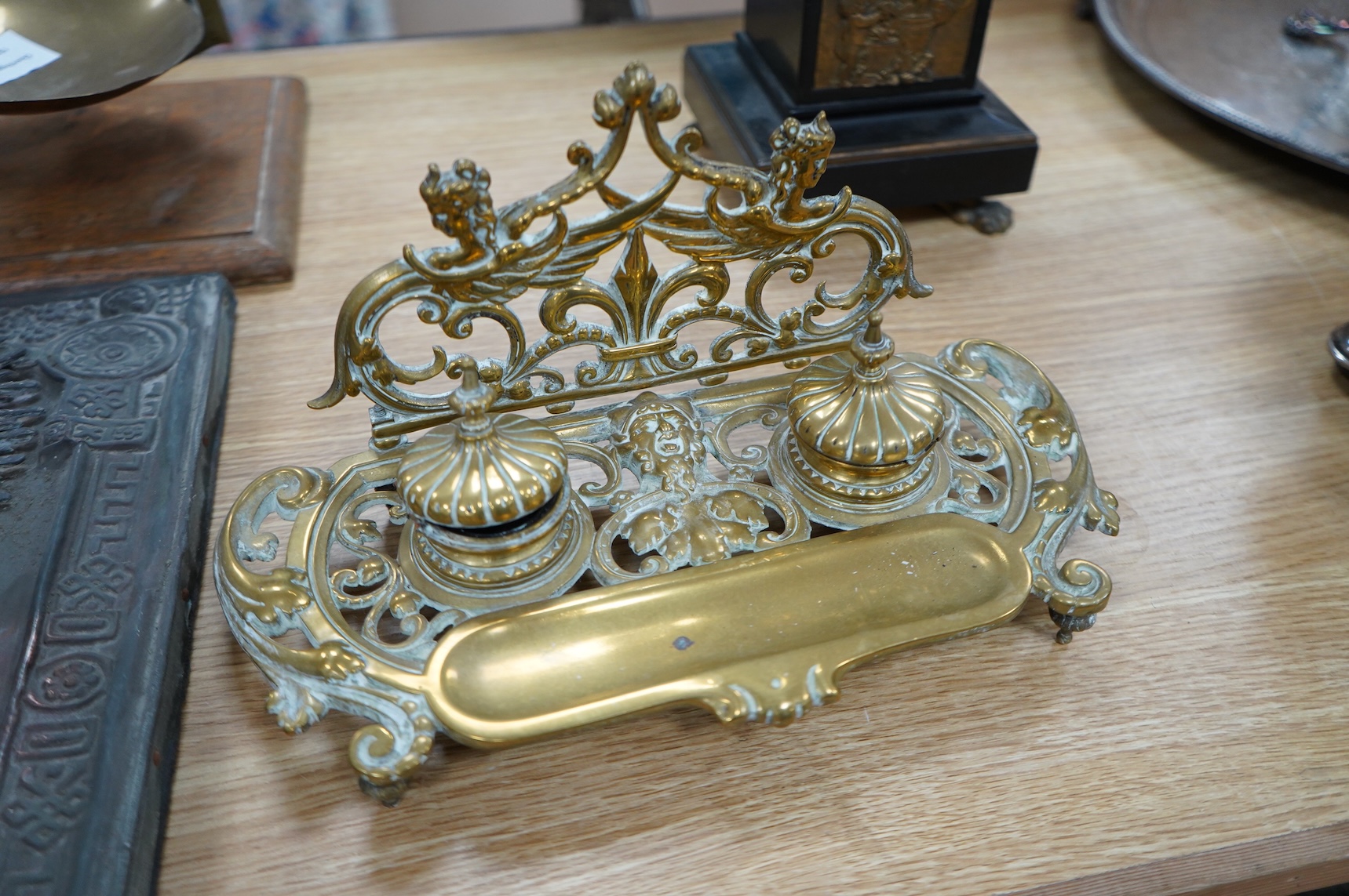 An early 20th century ormolu and marble ‘cherub’ converted candelabra and a brass desk stand, tallest 56cm